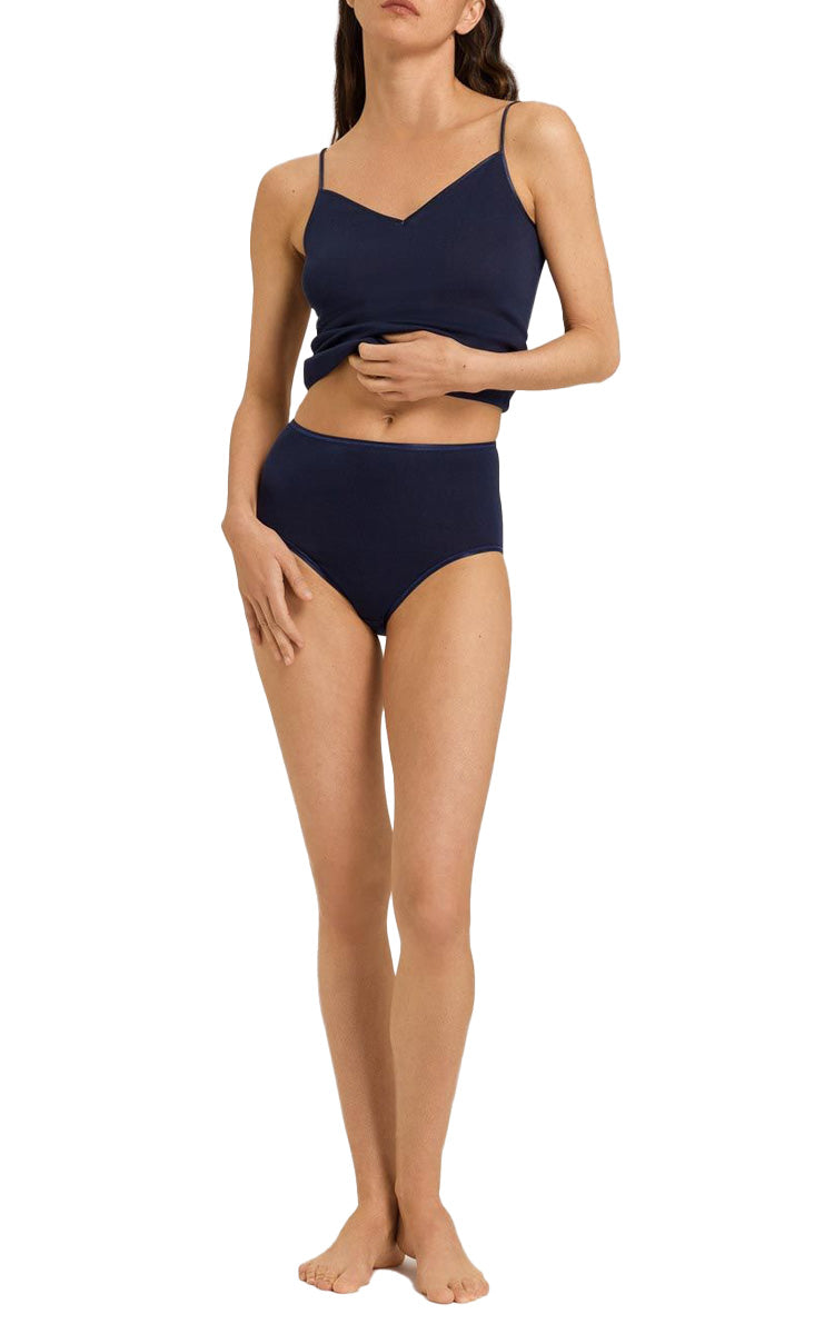 Woman wearing Hanro navy camisole in pure cotton with string straps